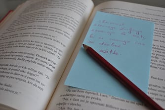 pencil and note on book